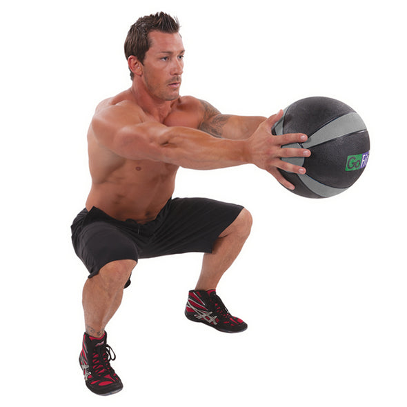 Male holding Med Ball with outreached arms in squat position