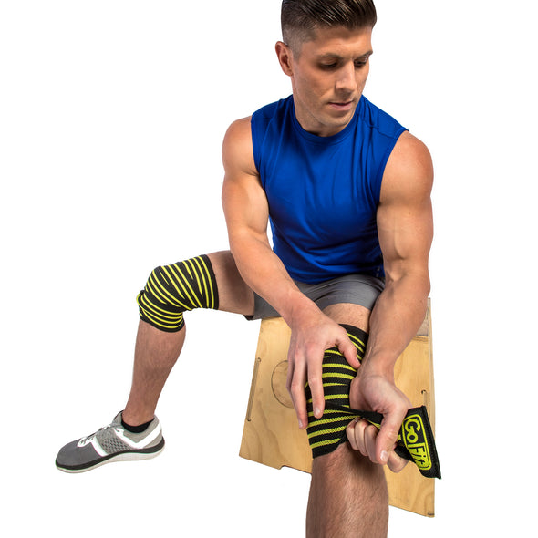Male putting on Ultra Pro Knee Wraps